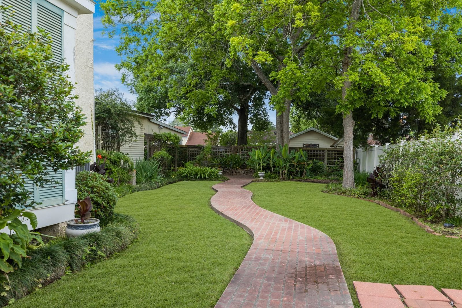 The garden path at The Caldwell House curving past banana plants and flower beds