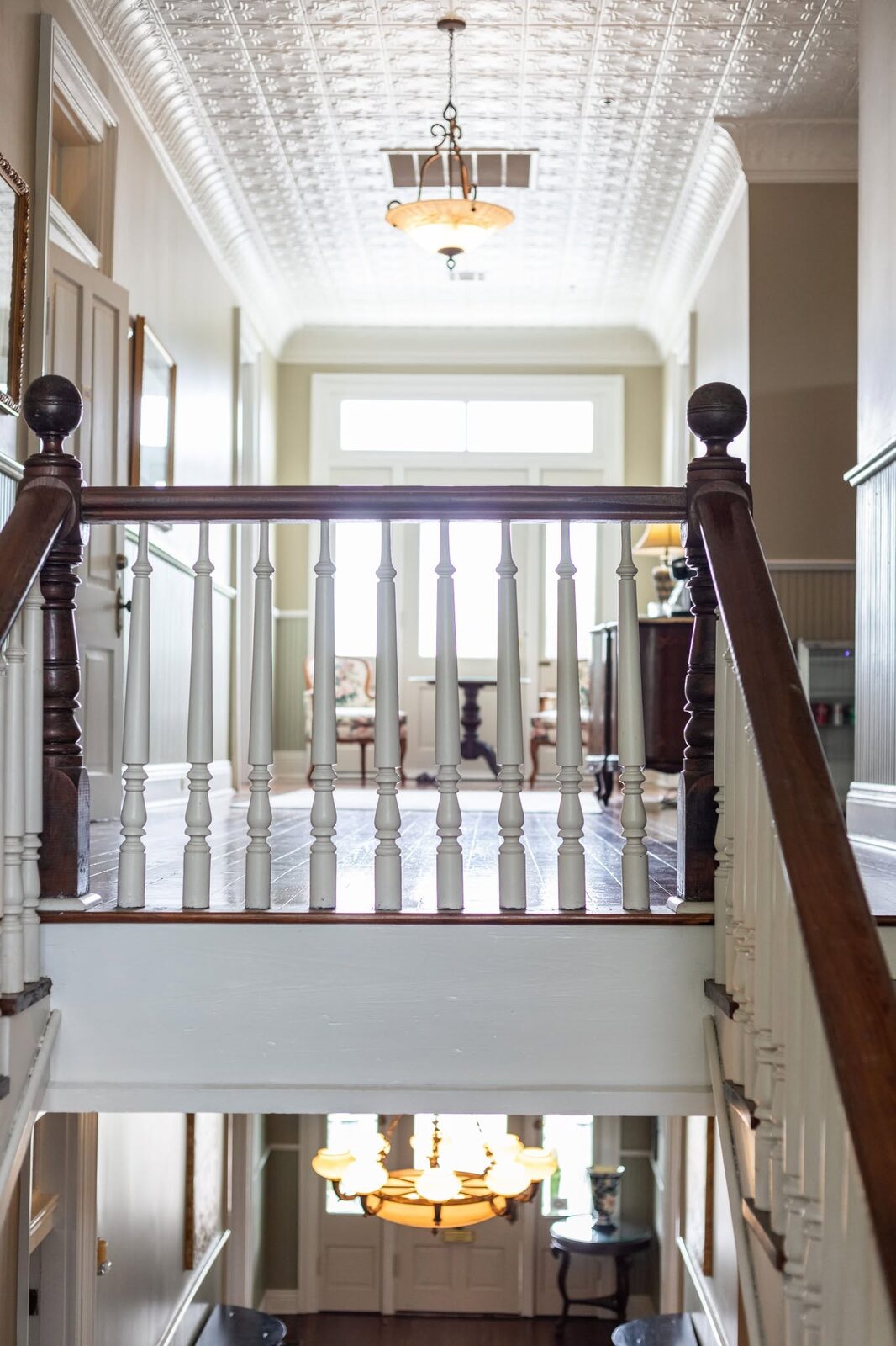 A landing beneath an original pressed-tin ceiling in one of our historic venues