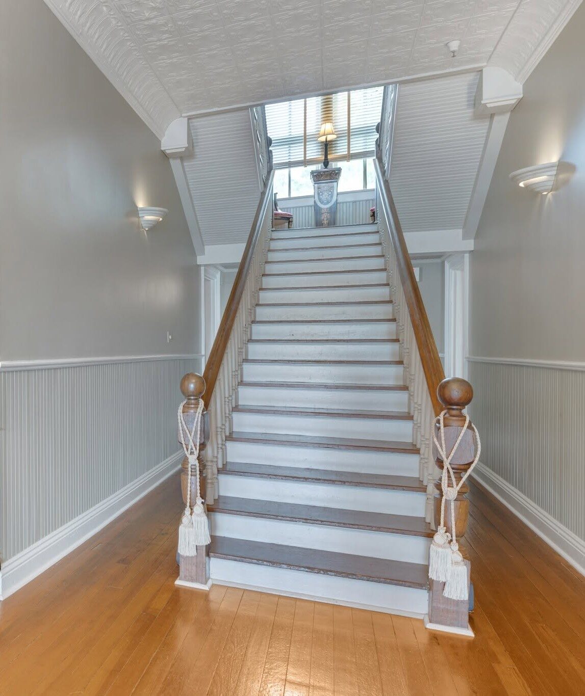 A grand wooden staircase turning upward inside one of our historic venues
