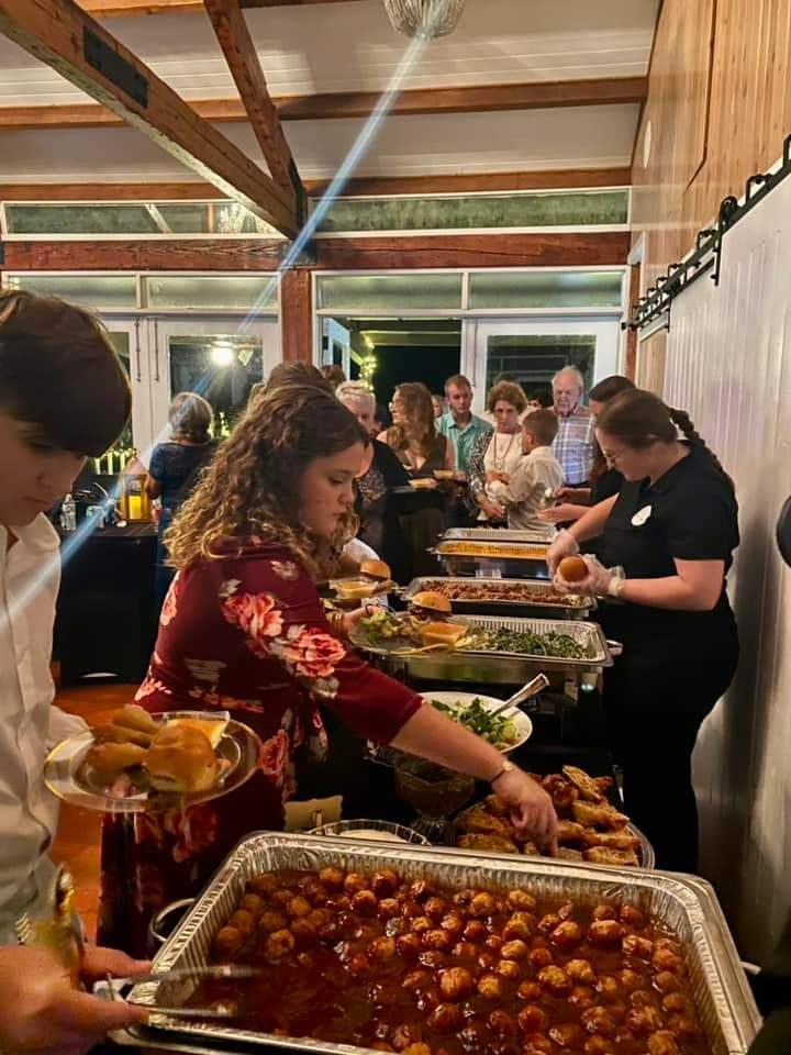 Our team dressing plates and welcoming guests down the supper line at a wedding reception